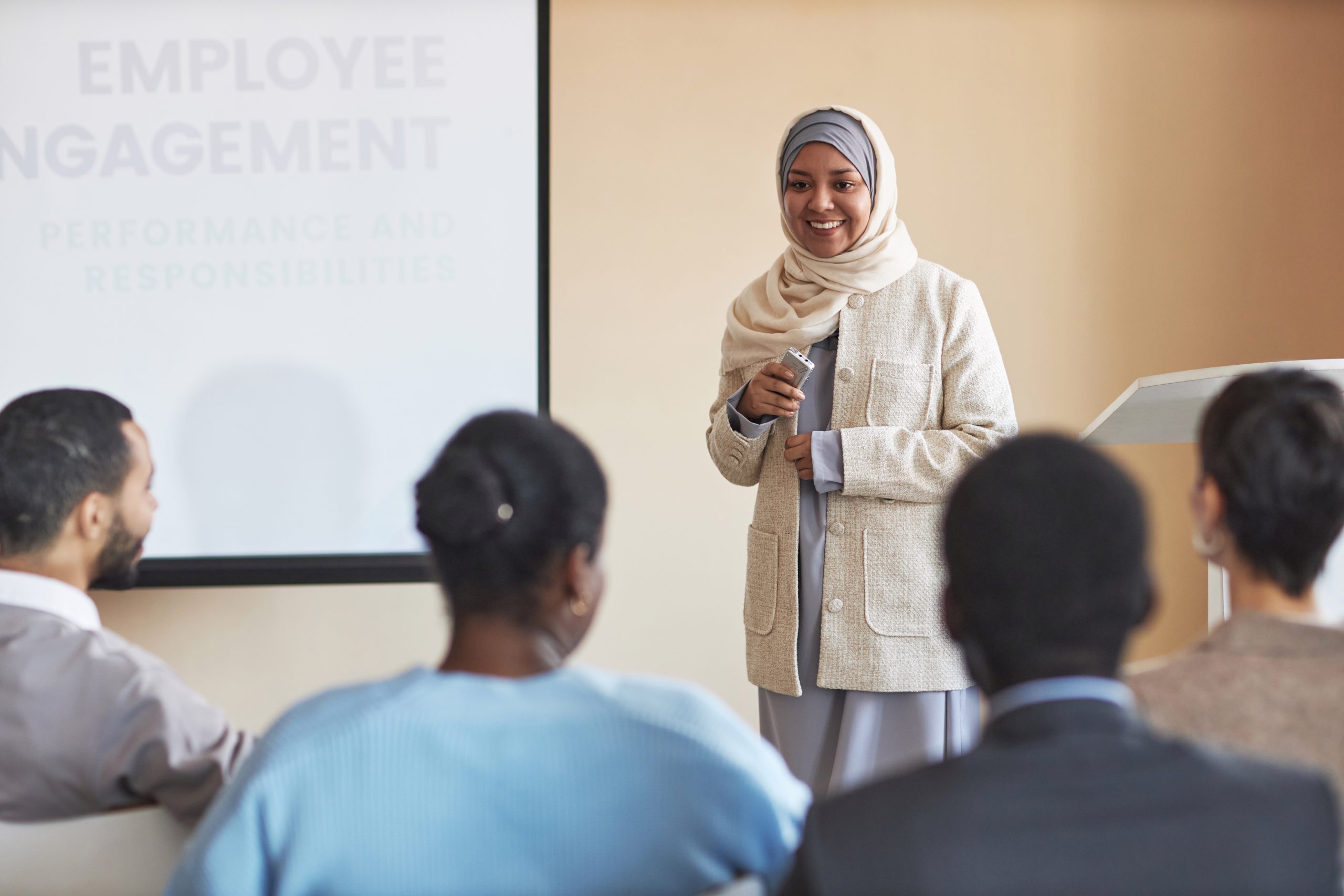 woman presenting employee training videos to audience